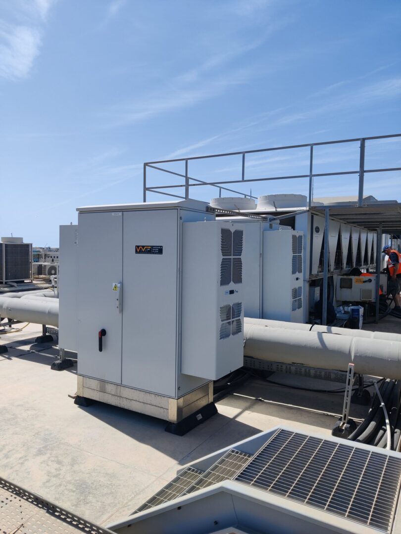 Rooftop HVAC units under clear blue sky.
